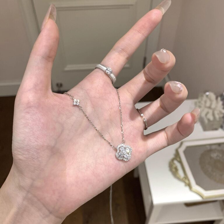 Silver lucky clover CZ necklace worn on hand main image