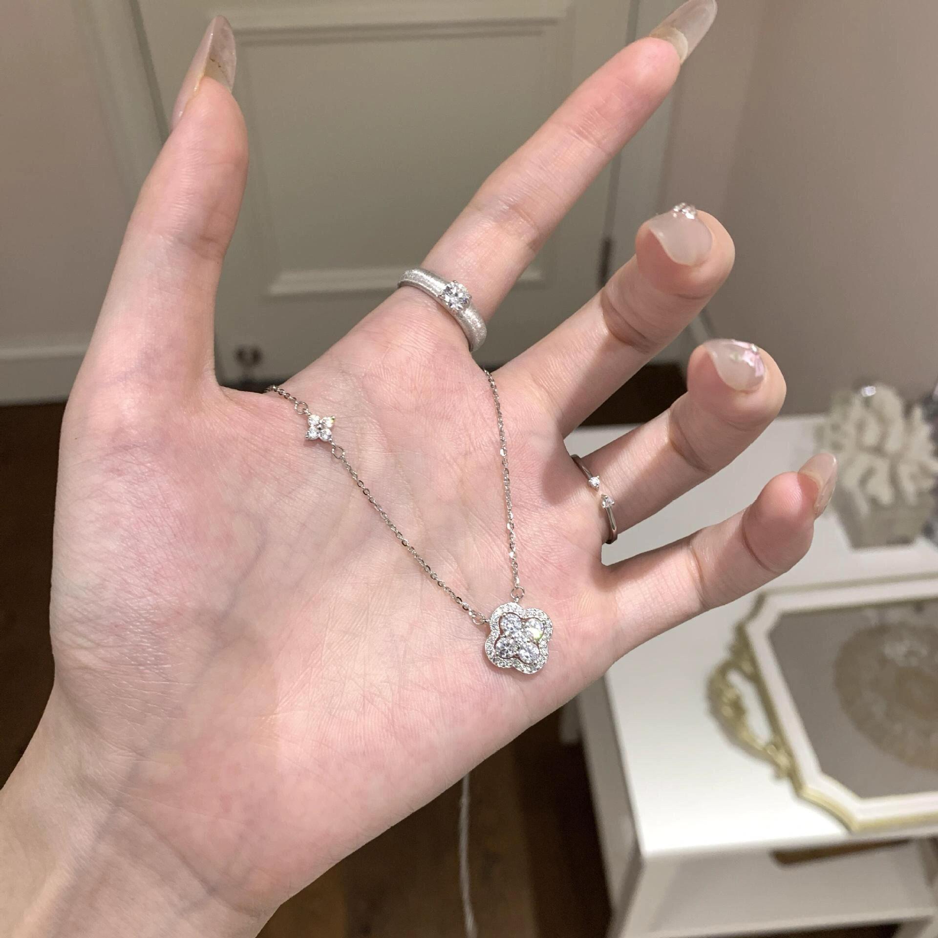 Silver lucky clover CZ necklace worn on hand main image